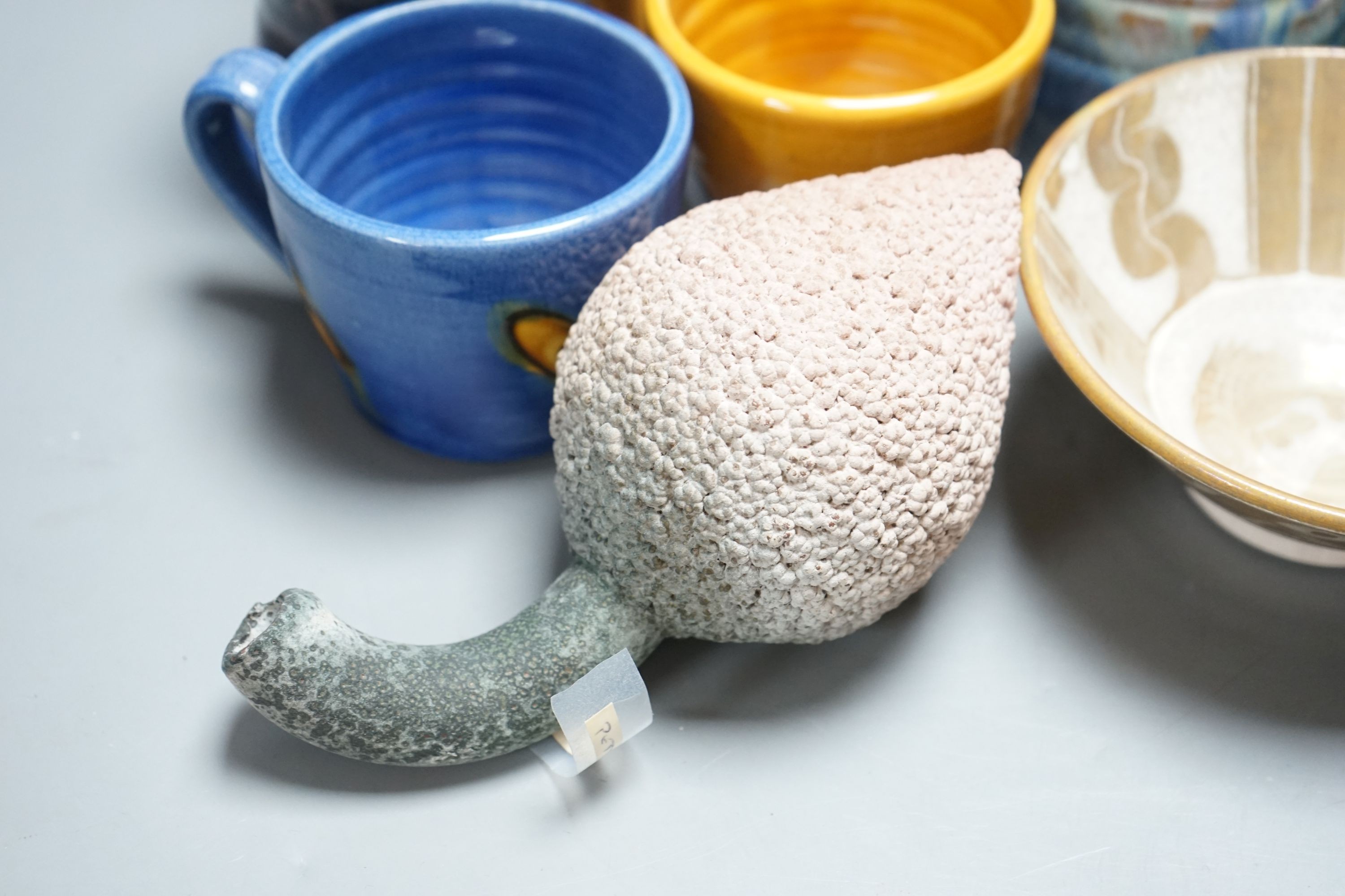 A group of studio pottery jugs, mugs, and other vessels to include –